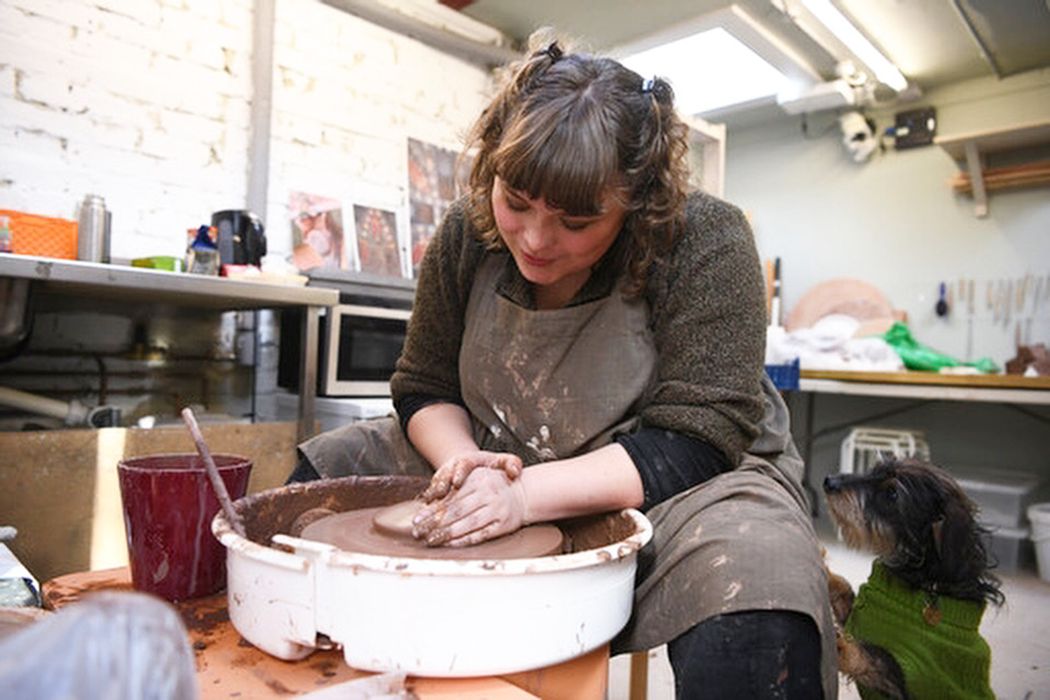 Artist Ashleigh Fisk at her pottery wheel