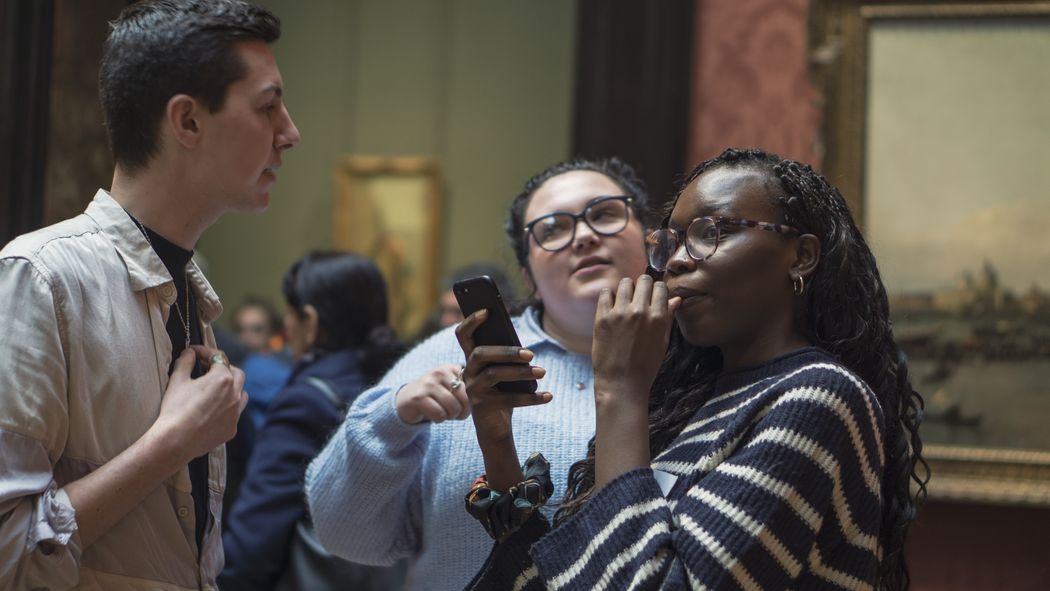 Young people using the smartify app in a gallery setting